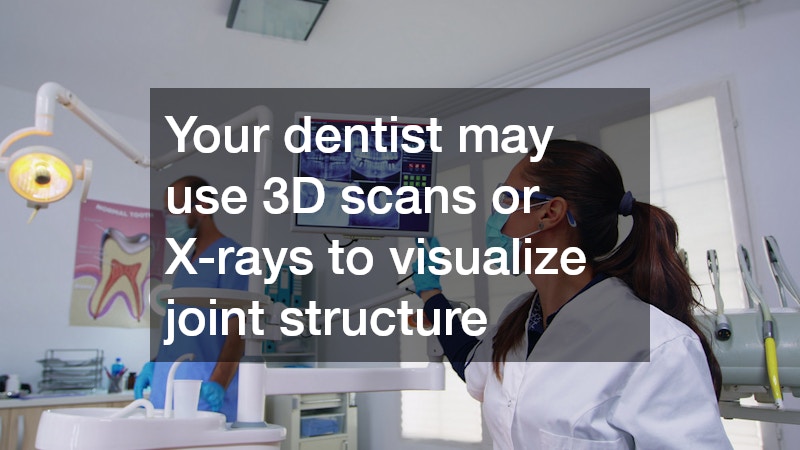 dentist viewing a digital monitor showing a full mouth X-ray